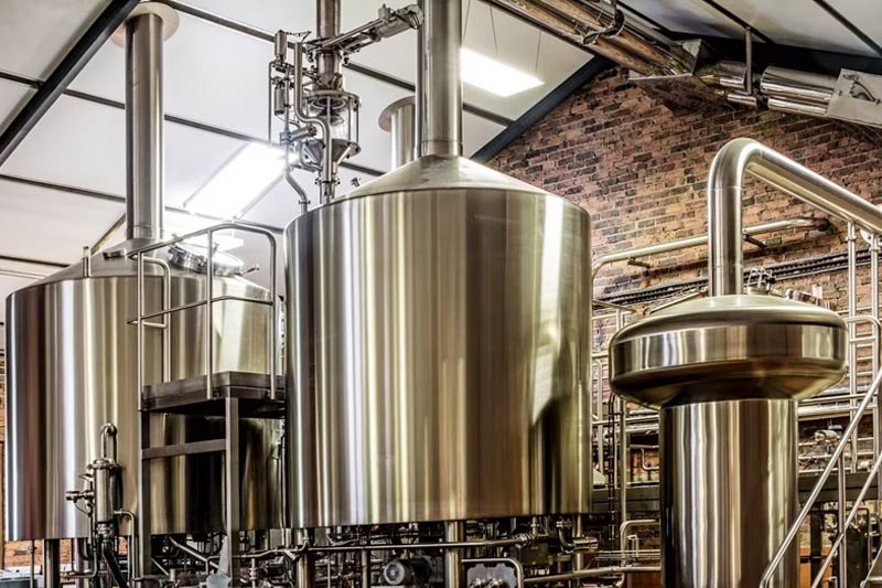 What is a beer filtration system used for and how does it work in a commercial brewery?